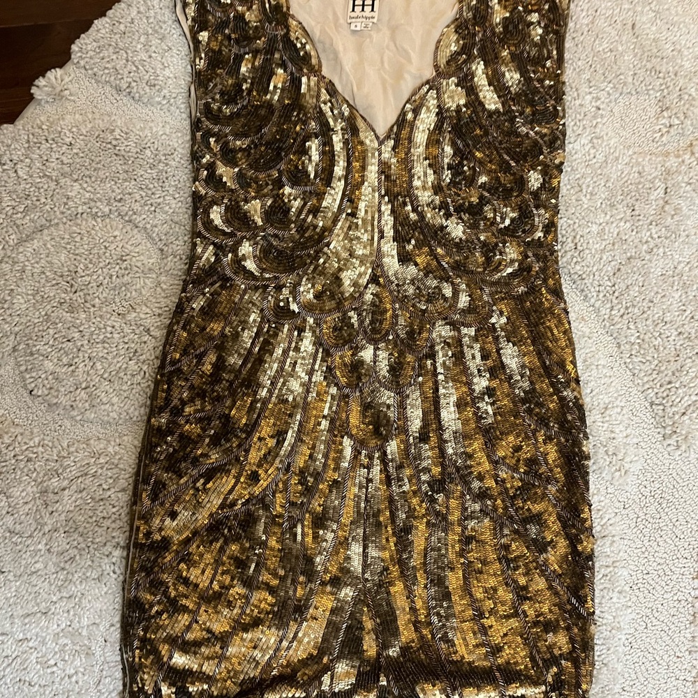This is a gold sequined designer dress in a size 8 Designer is HH haute hippie.